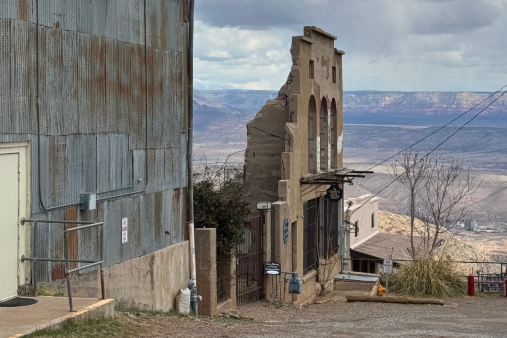 Abandoned building in Jerome, Arizona, with mountains in the background
