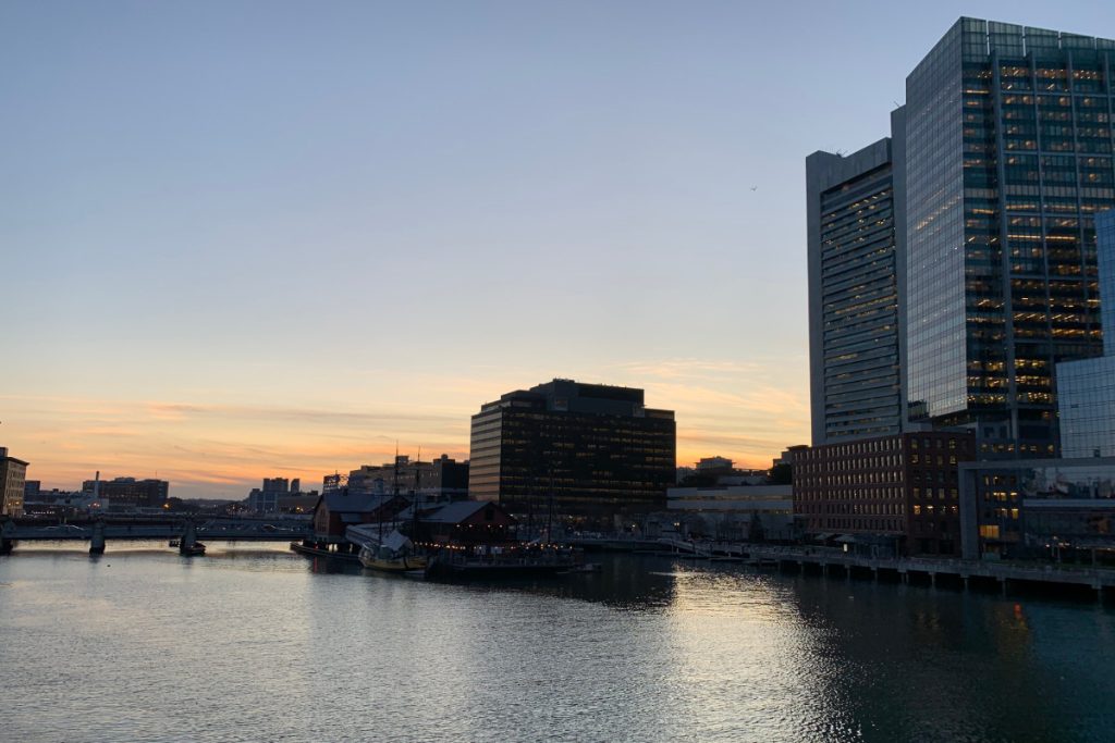 Photo of Boston Harbor showing tall buildings on edge of water