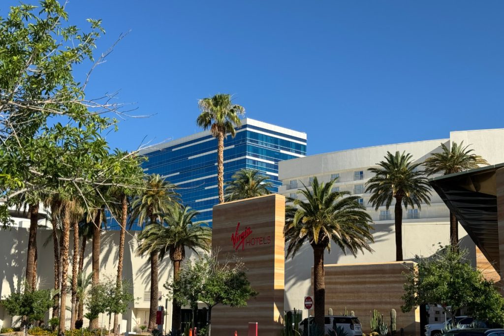 Exterior shot of Virgin Hotel, Las Vegas with palm trees