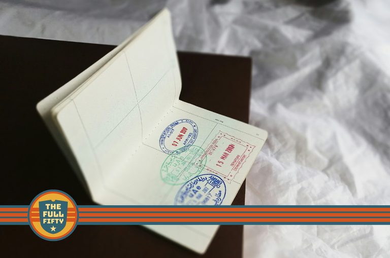 Photo of an open passport, with visa stamps. There's an overlay of The Full Fifty logo